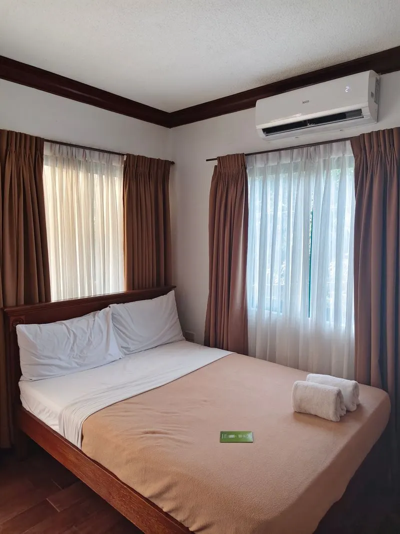 Bedroom with a ductless mini-split unit mounted on the wall above the bed