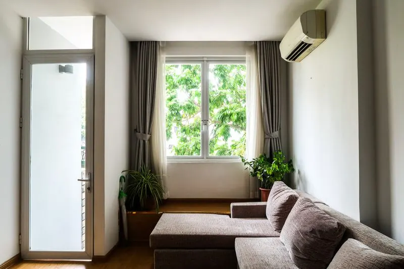 Ductless mini-split unit mounted high on the wall of a bright living room
